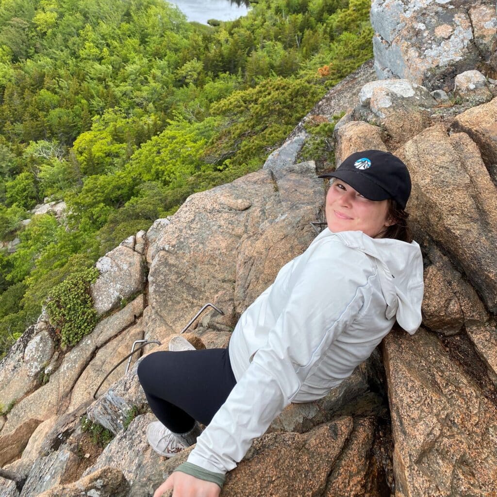 Alyssa Kopsidas sitting on a hill