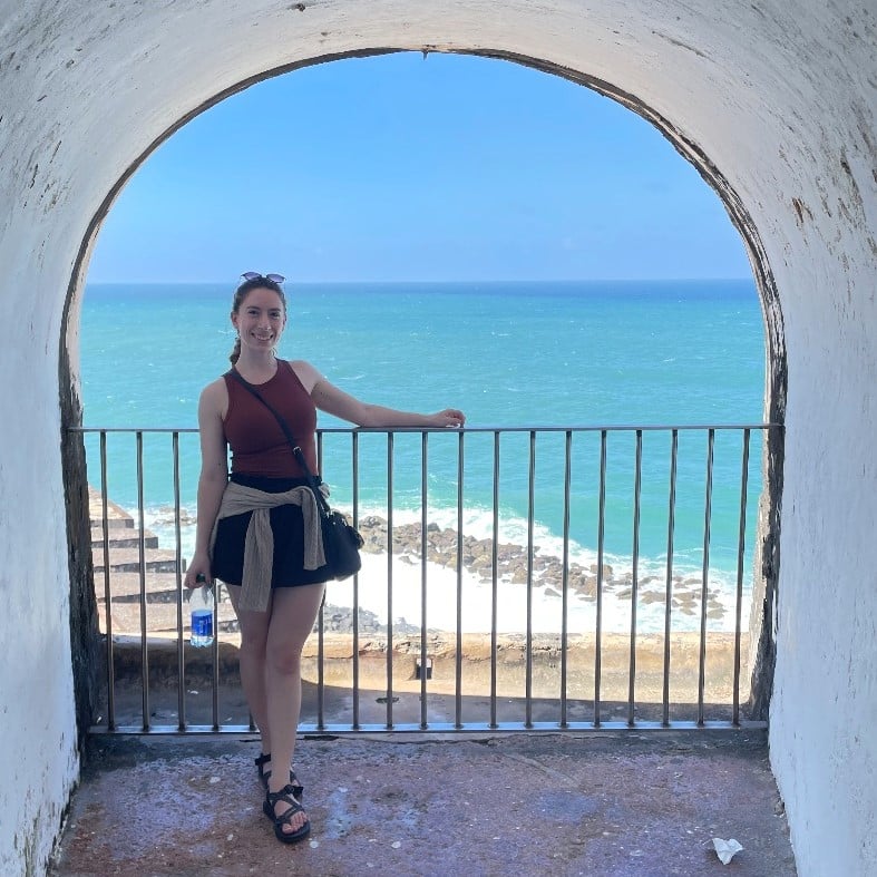 Amanda Fleres standing by a view of the ocean