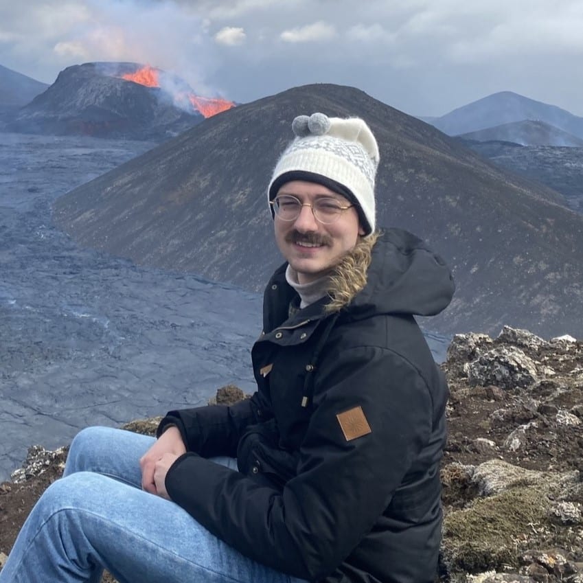 Andrew Medlin in front of a volcano