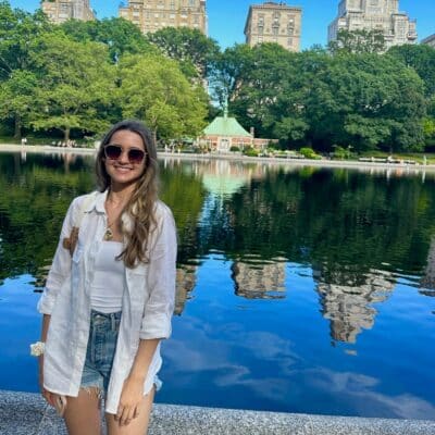 Angela Koziarz in front of a river and old buildings