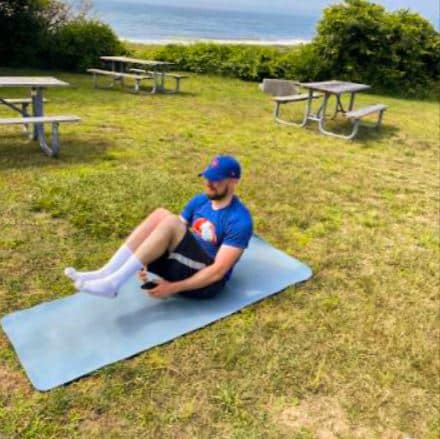 Matthew Dolan exercising outdoors on a gym mat