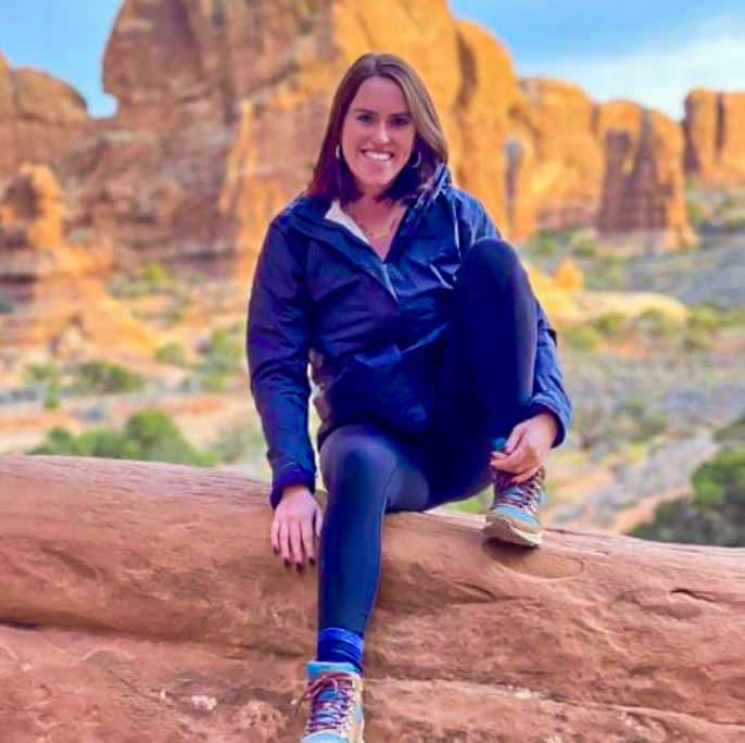 Meghan Hartigan travel picture in desert sitting on rock