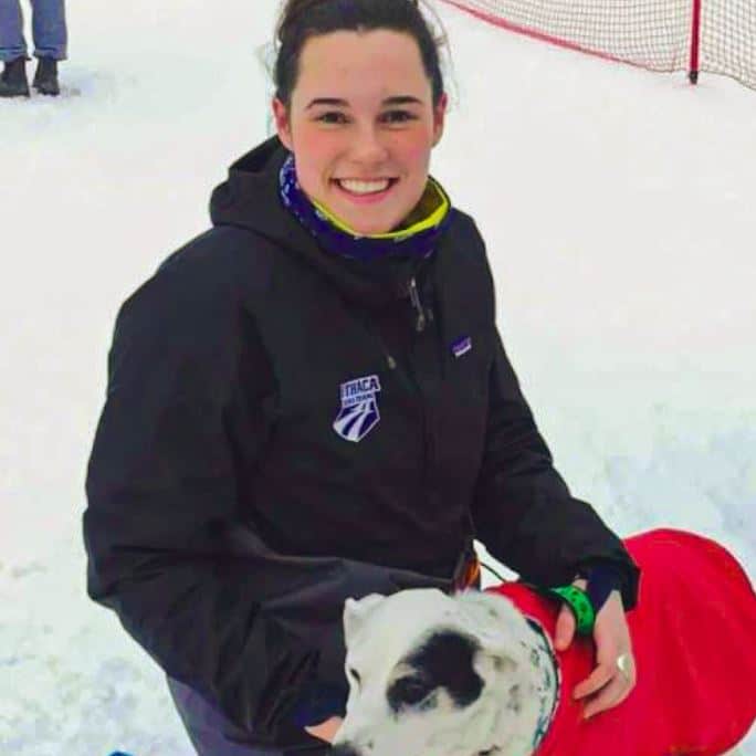 Cailin Dix playing with dog in snow