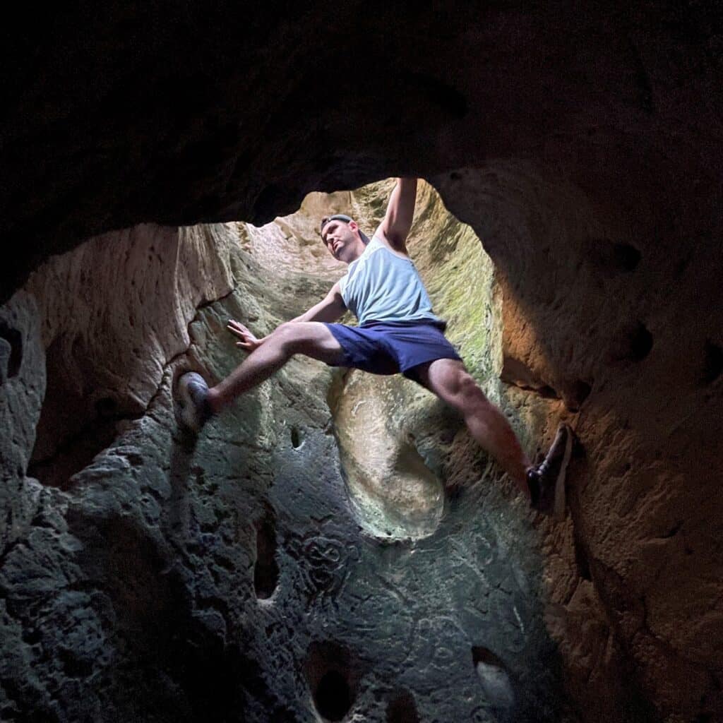 Dylan Pearce climbing in a hole