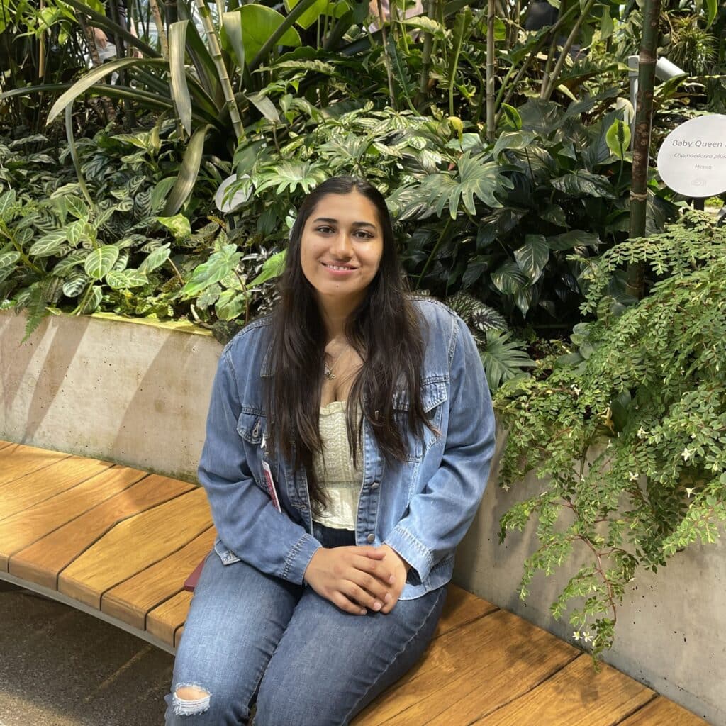 Eisha Joshi sitting by a garden