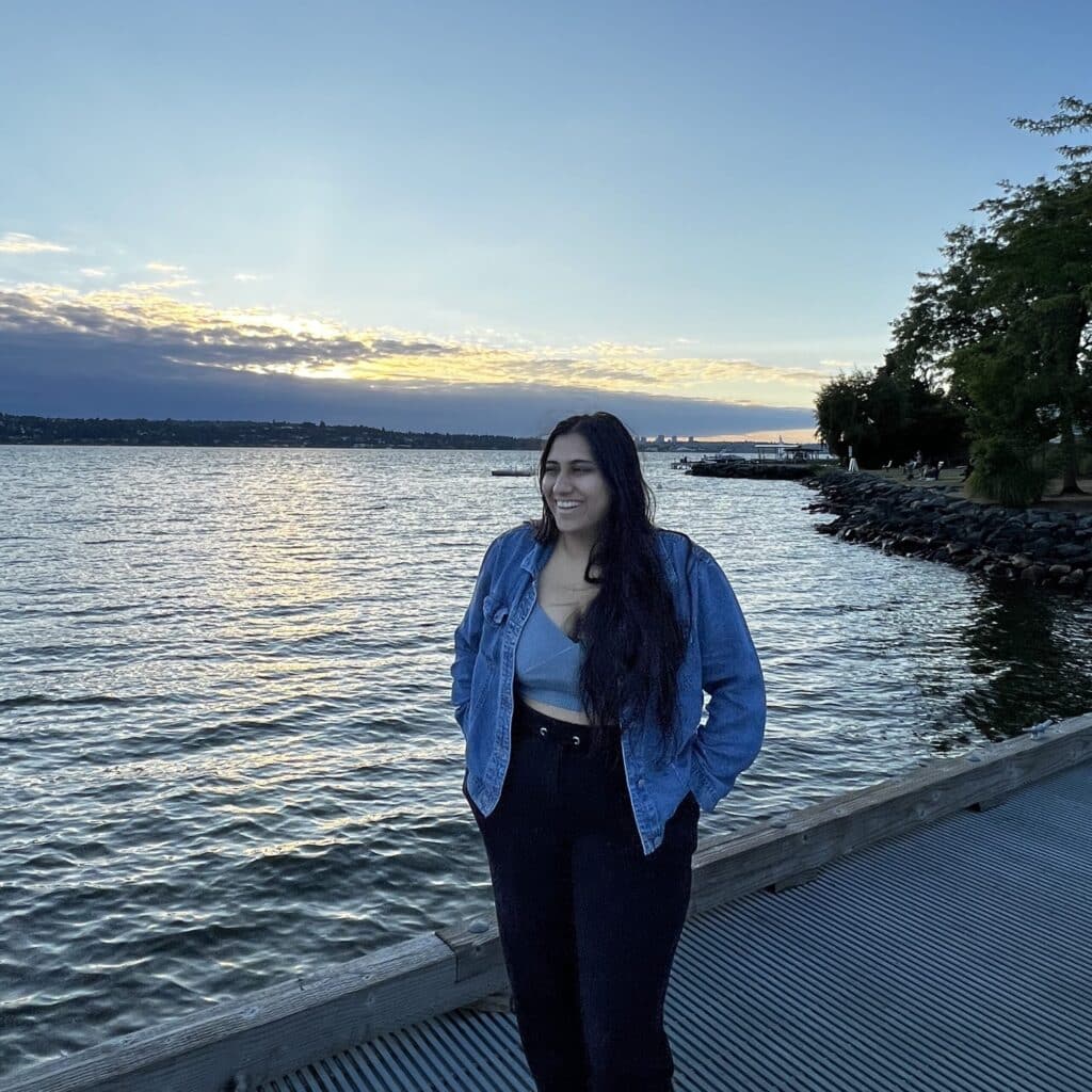 Eisha Joshi standing in front of the sunset