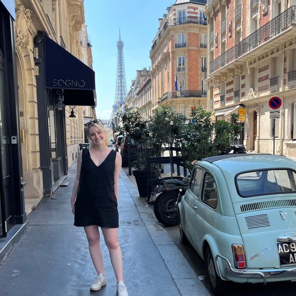 Emily Loftus in paris streets with eiffel tower in back