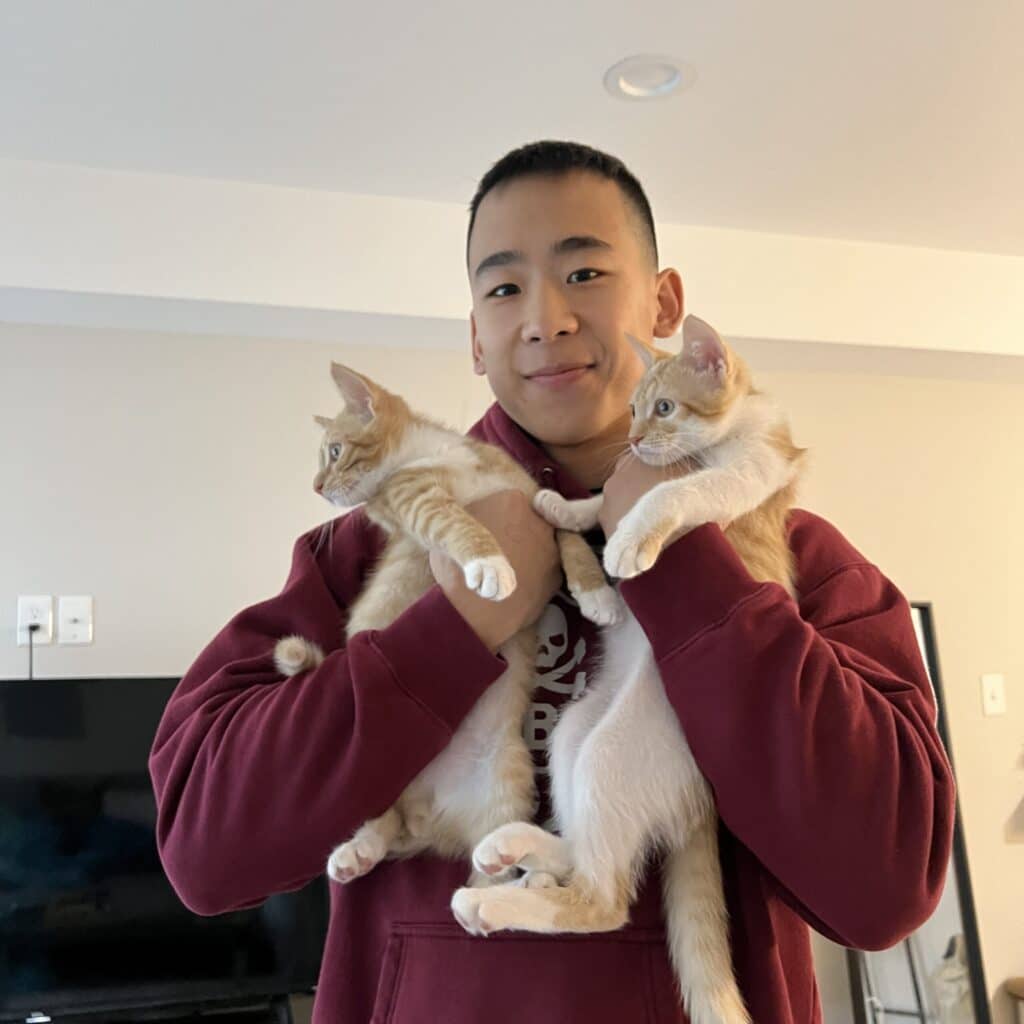 Evan Chang holding his cats