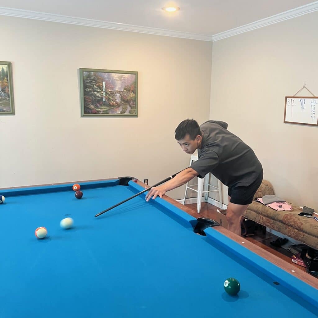 Evan Chang playing billiards