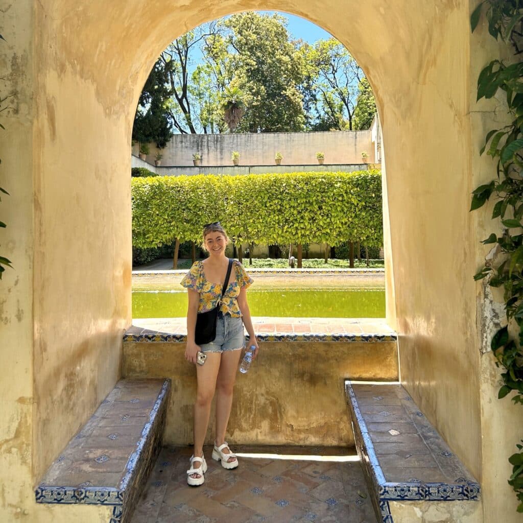 Evelyn Russo in front of a window looking at a garden