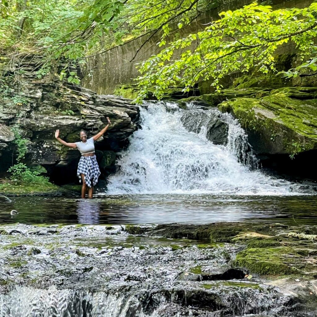 Fatou Dieye standing in a river