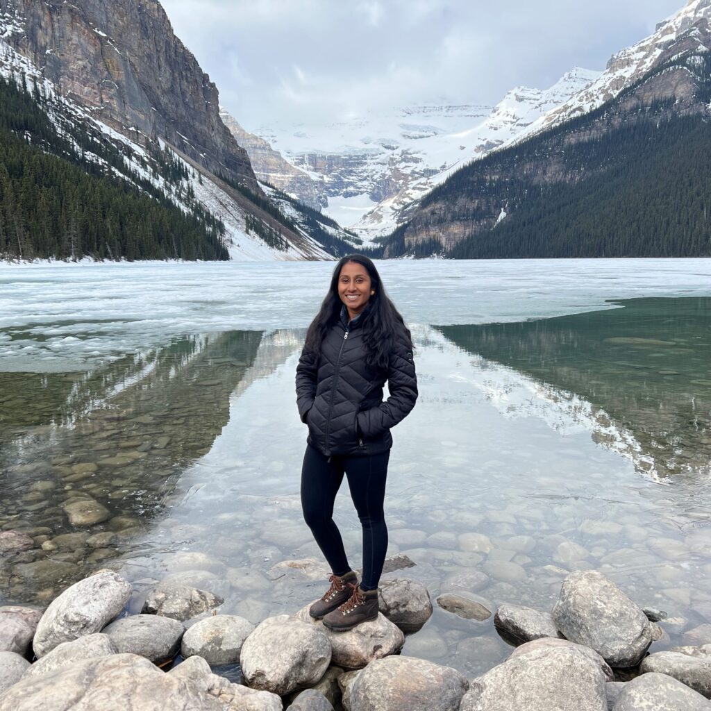 Garavi Angreji standing in front of an ice lake