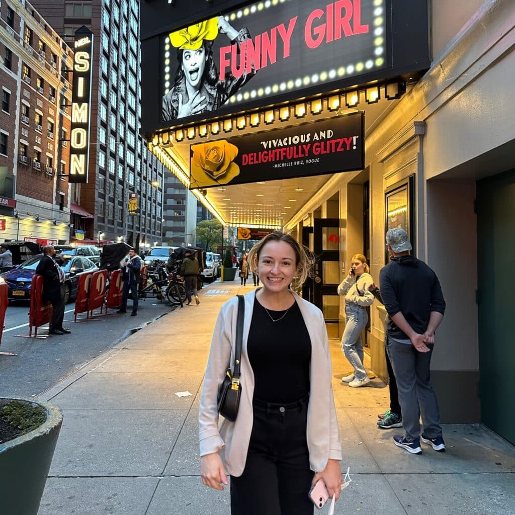 Georgina Genovese in front of broadway show sign