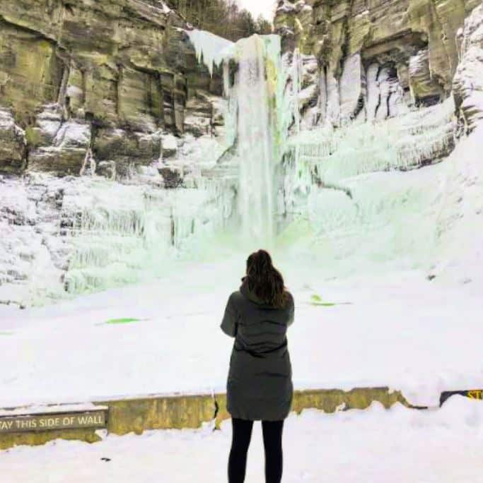 Cailin Dix in front of frozen waterfall