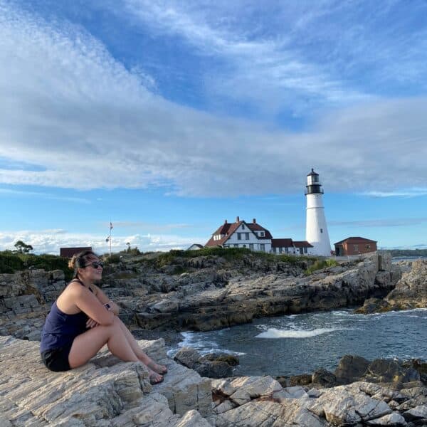 Jenny Leung sitting by a lighthouse