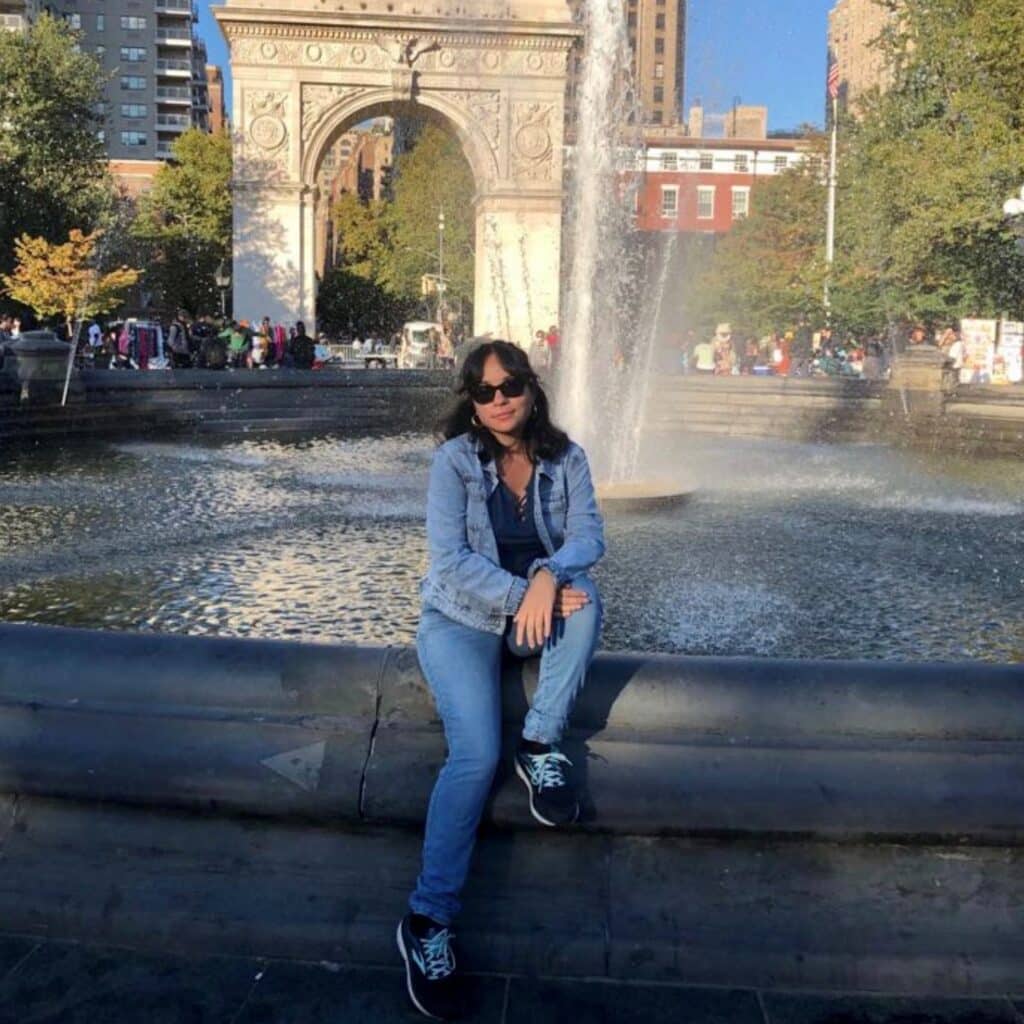 Kathleen Siano sitting on a fountain