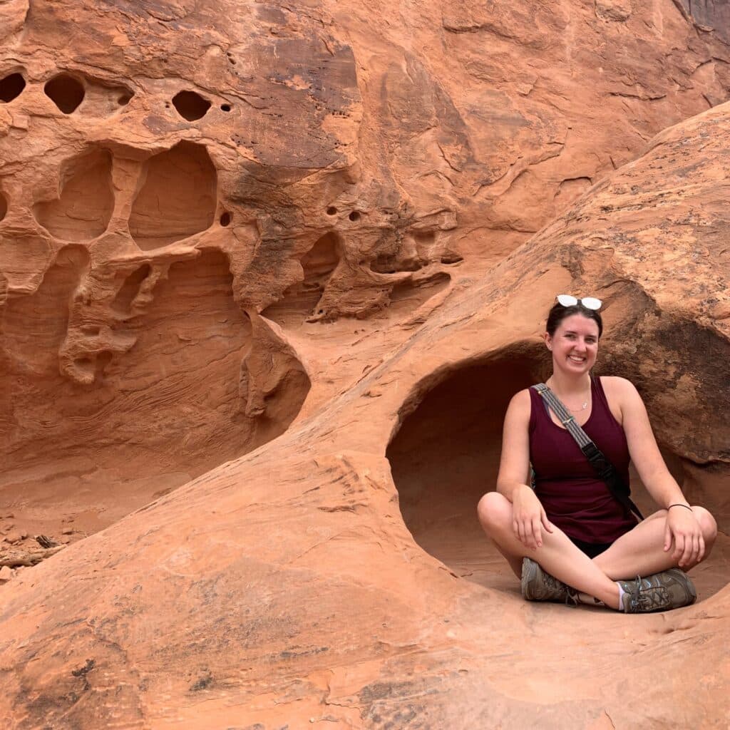 Madison Witt sitting in a rocky mountain