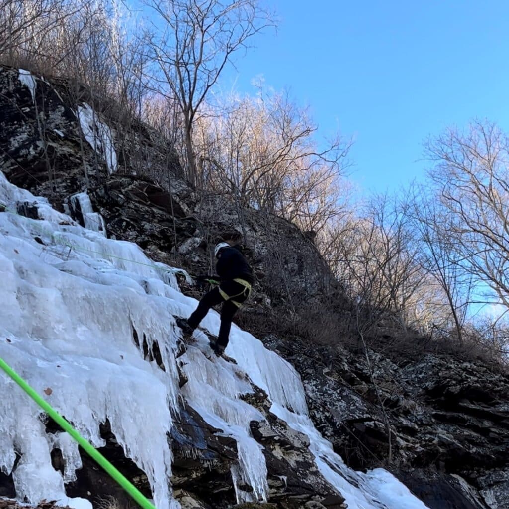 Matthew Tingson climbing a mountain