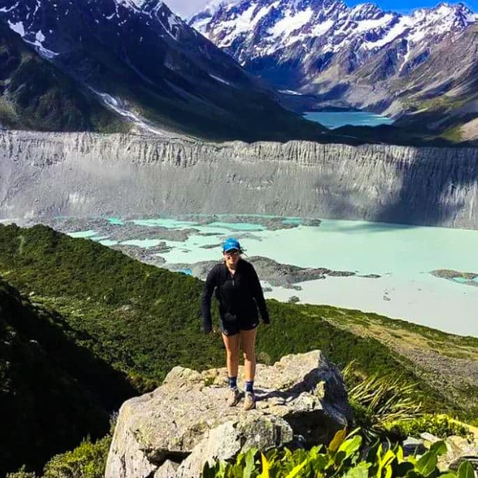 Cailin Dix hiking, on top of mountain overlooking crater