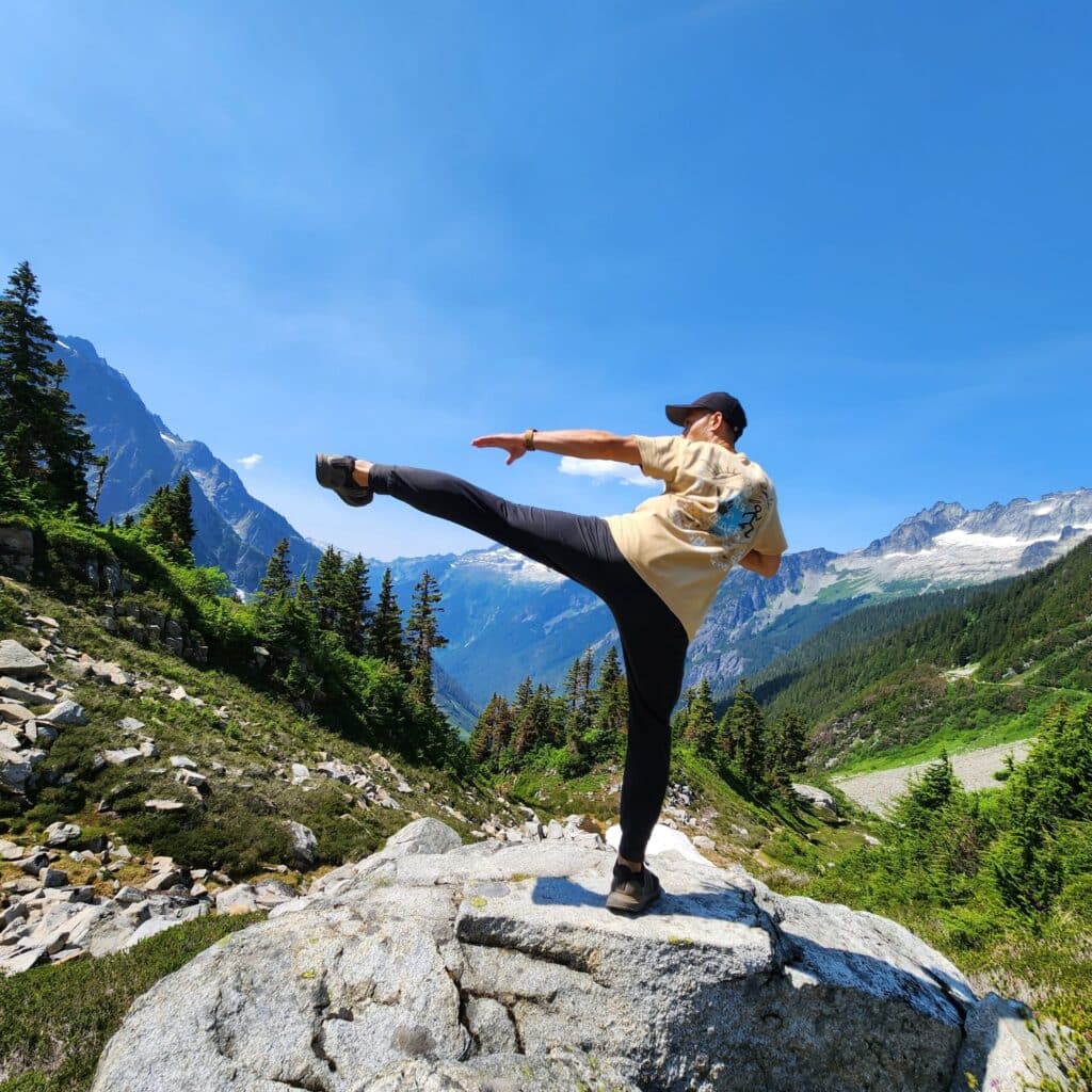 Tony Ng doing karate on a rock