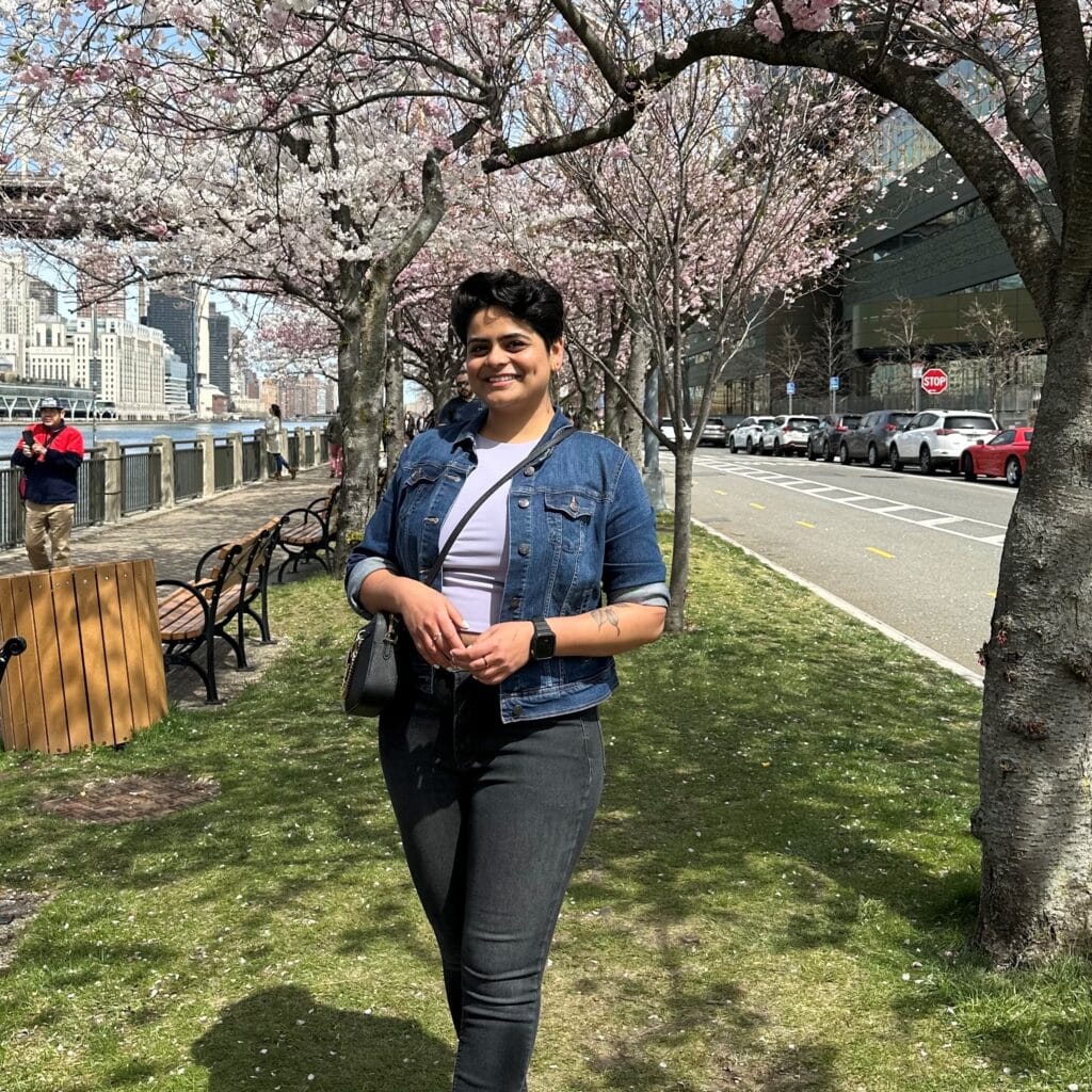 Ninisha Patil in front of cherry blossums