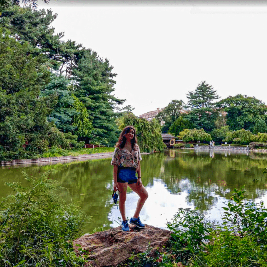 Sejal Kadam portrait in front of pond in botanical garden