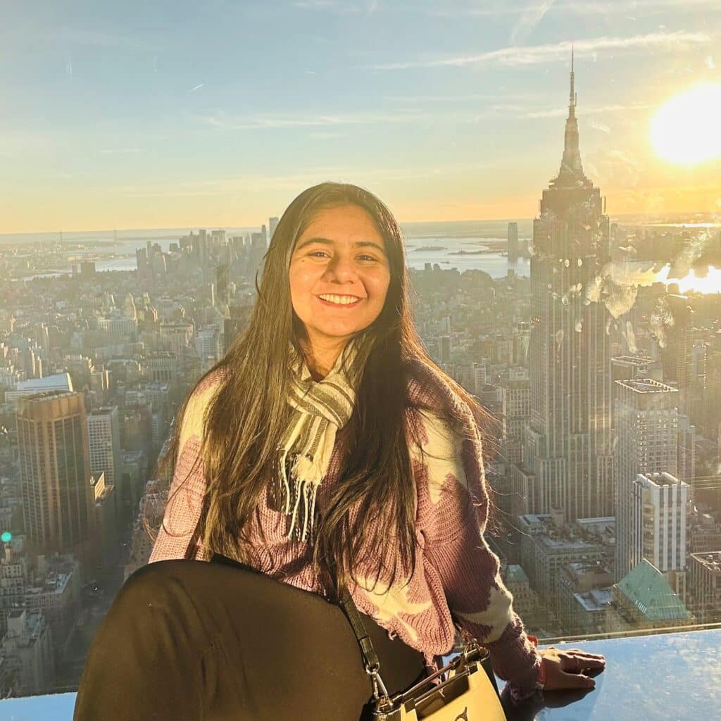 Radhika Thakkar sitting in front of city overlook