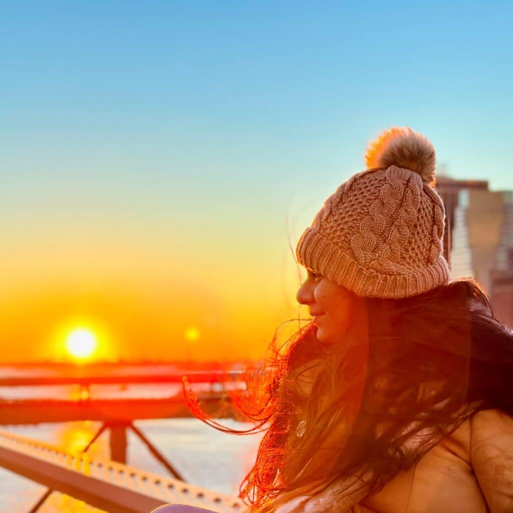 Radhika Thakkar sitting in front of sunset