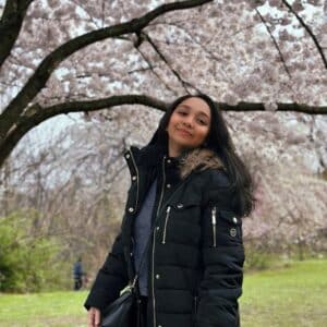 Resham Kadam in front of cherry blossums