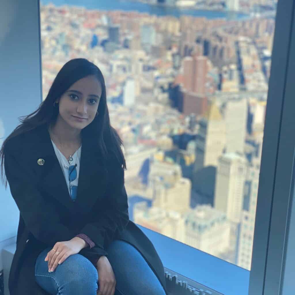 Shilpi kapoor sitting by a window overlooking the city