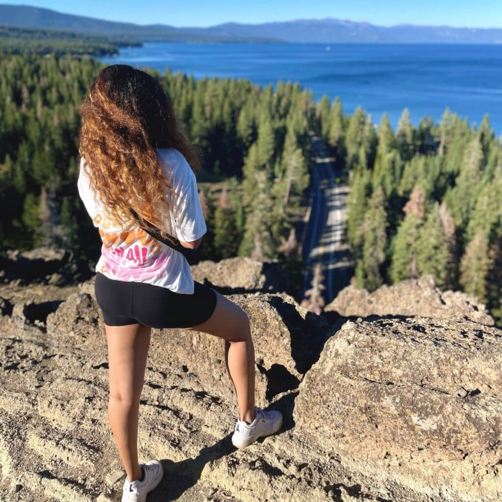 Simran Jaisinghani overlooking the ocean on a mountain