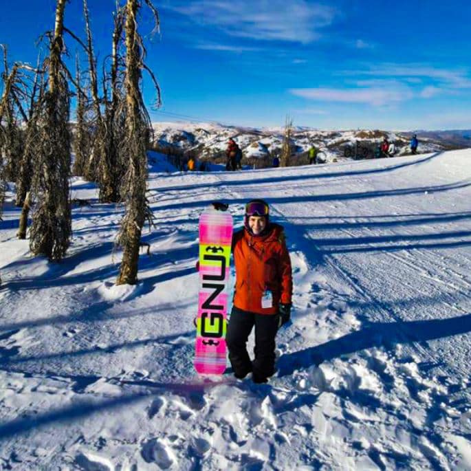 Melanie Gutierrez with snowboard on ski slope