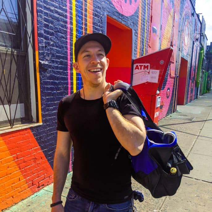 Peter Storm walking in front of colorful wall