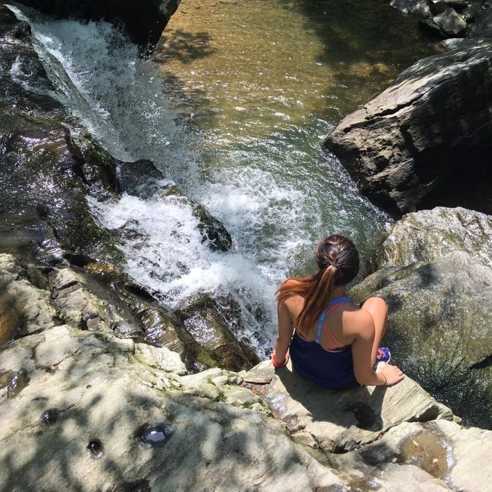 Alyssa Reyes in front of waterfall