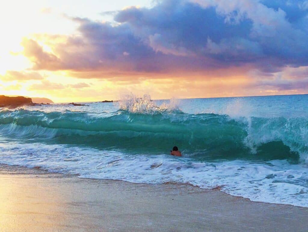 Colby Choi in shorebreak during sunset