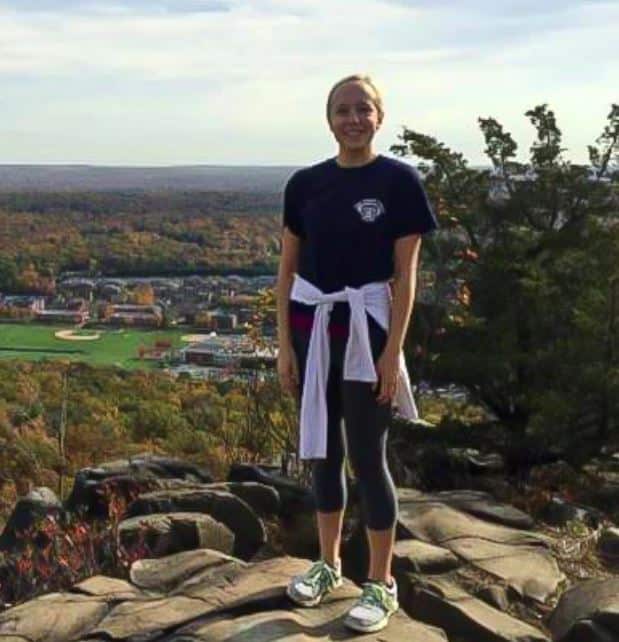 Deirdre McPartland on rock overlooking a village