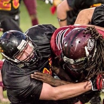 Donald Squire tackling during football game