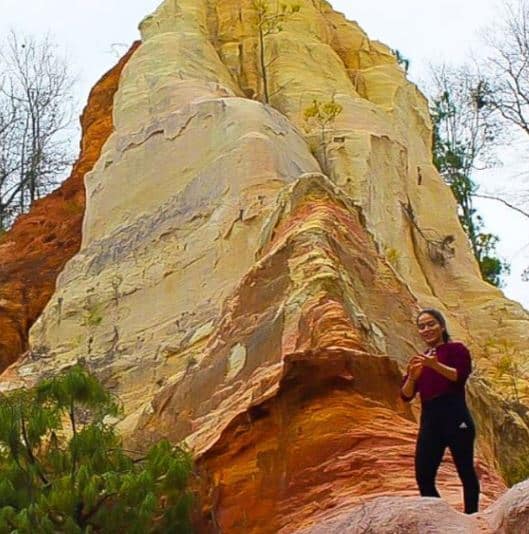 Michelle Sabogal hiking in front of rock formation