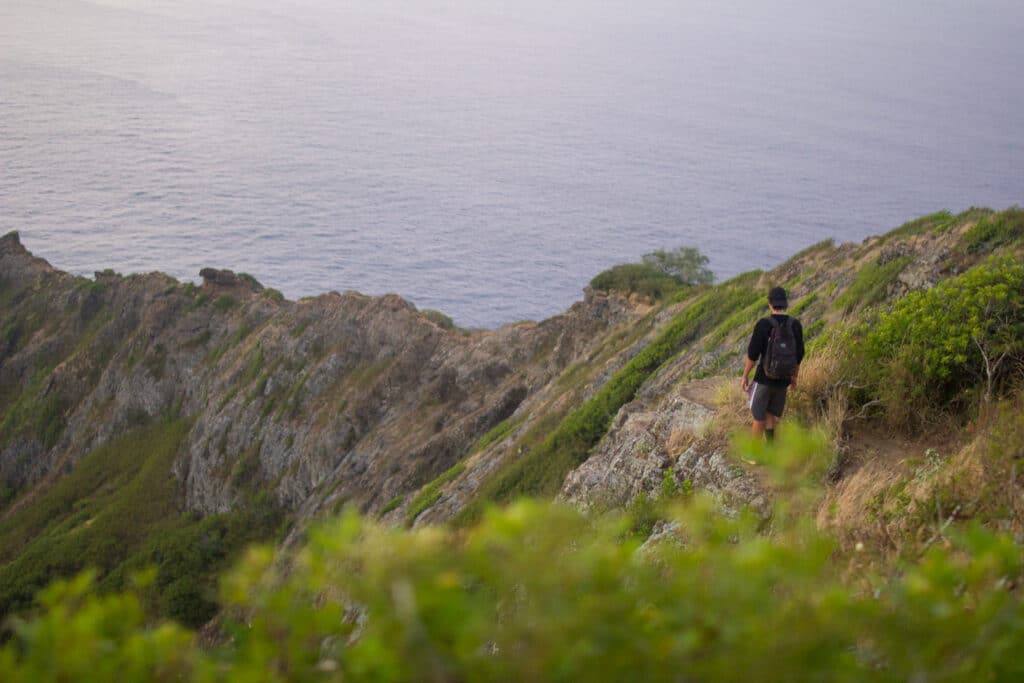 Scott Louis hiking on a mountain ridge by the sea