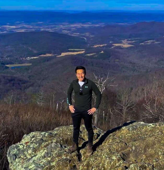 Jay Kwon standing on top of mountain top