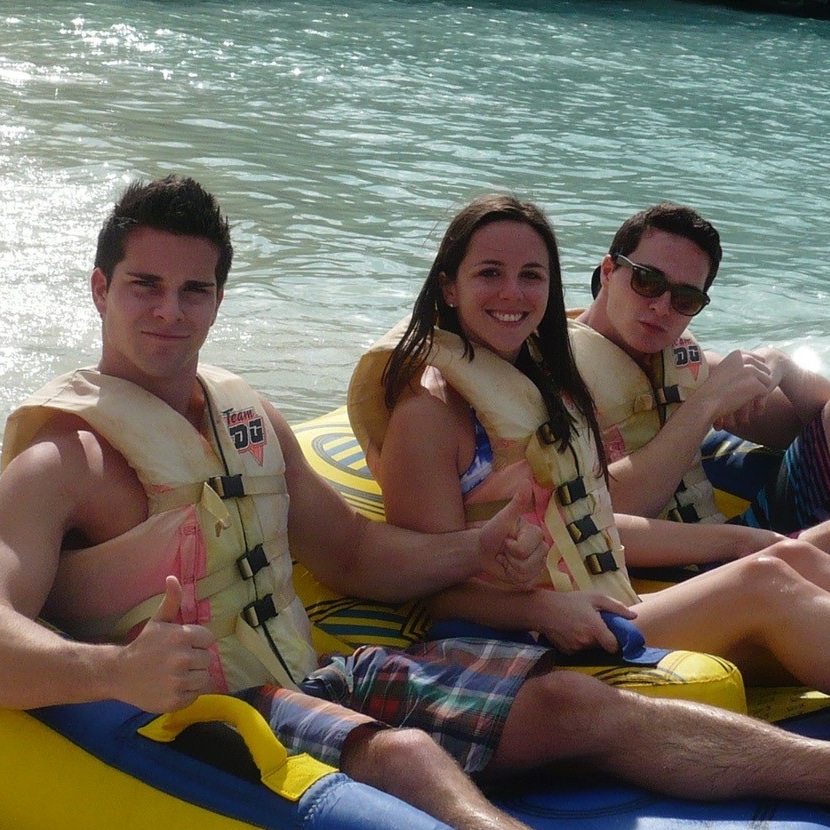 Joshua Kaufman rafting and doing thumbs up