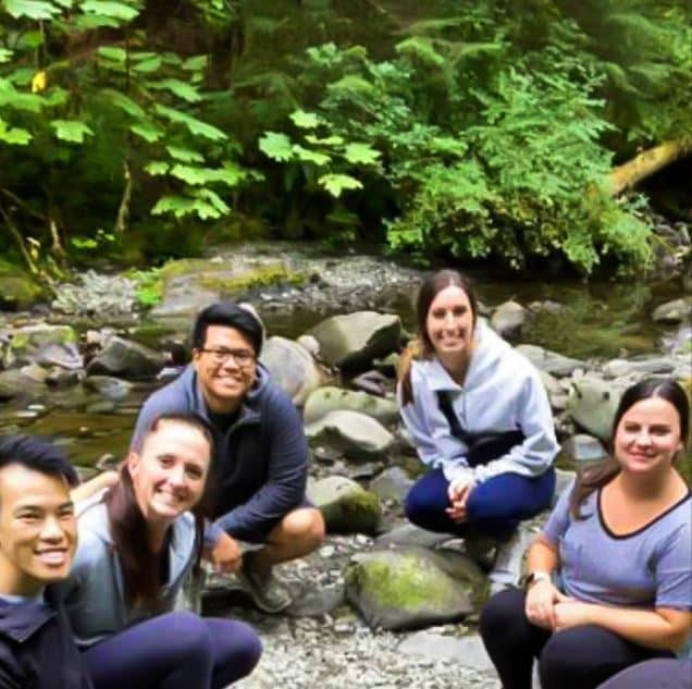 Andrele Reyes with friends sitting by creek