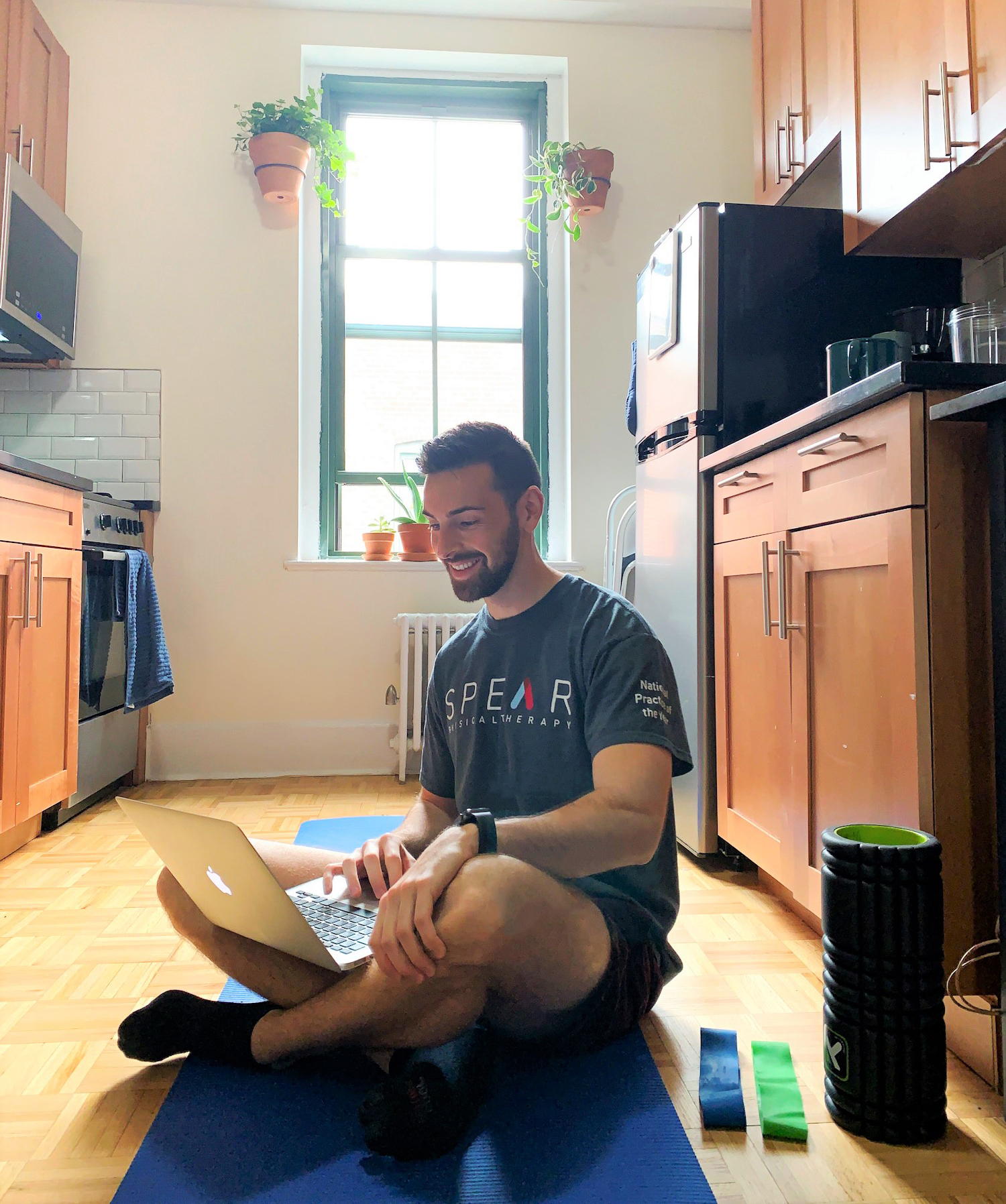 Physical Therapy instructor on laptop in kitchen