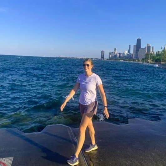 Jennifer Baudhuin walking on a pier near a skyline