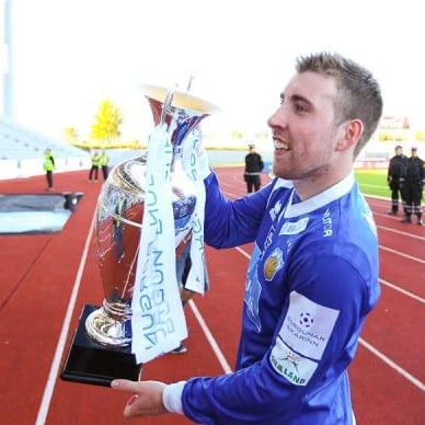 Alan Lowing lifting a soccer trophy