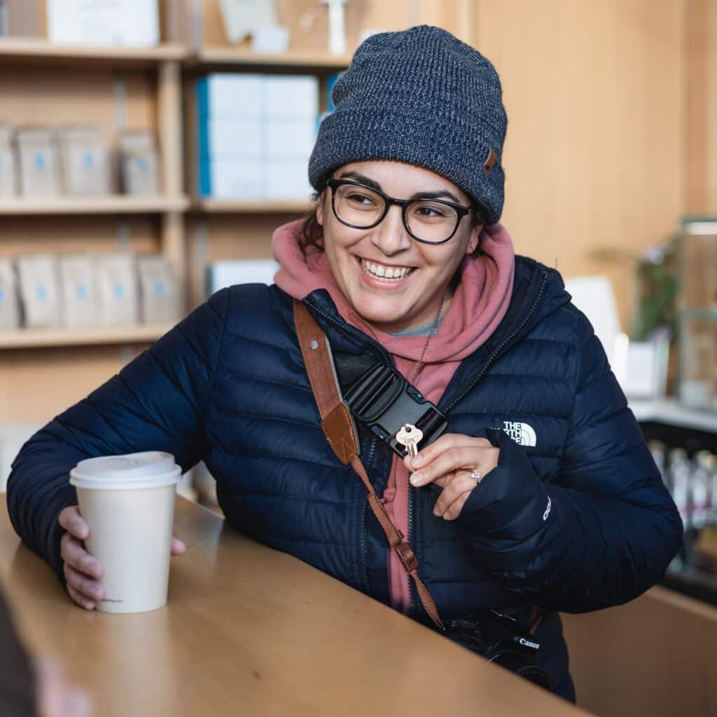 Beth Kines with key and coffee in coffee shop