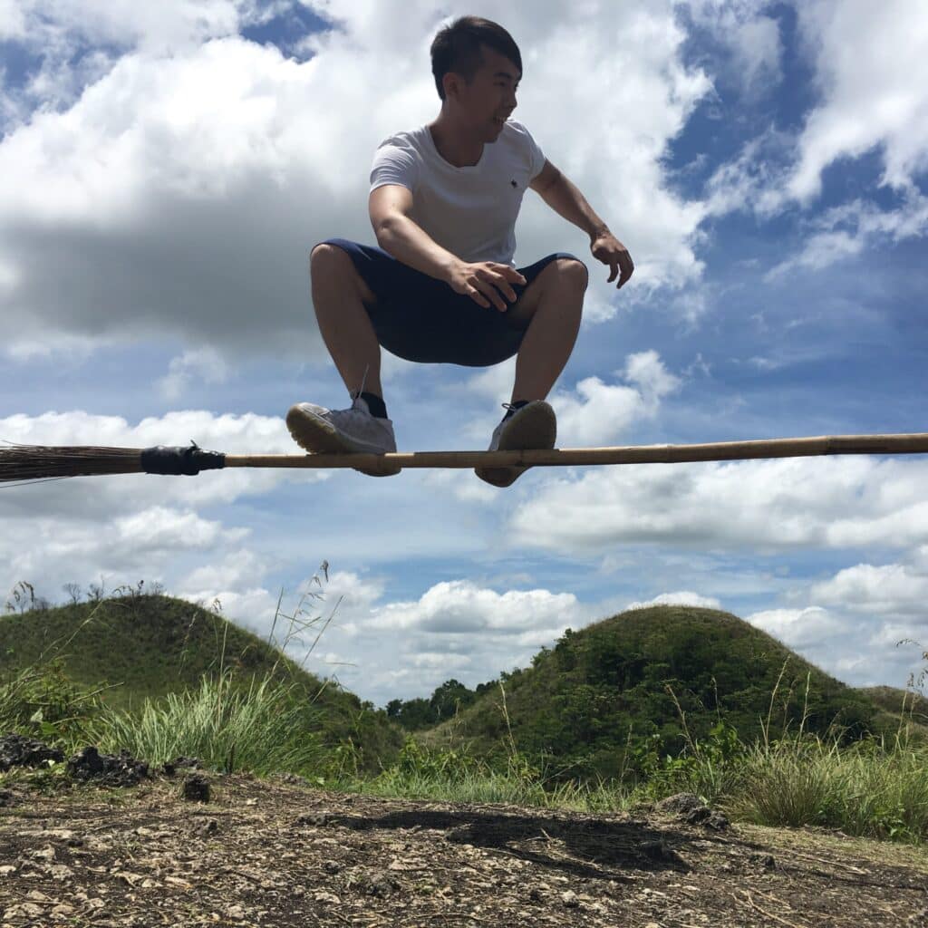 Chon Leong riding a broomstick like Harry Potter