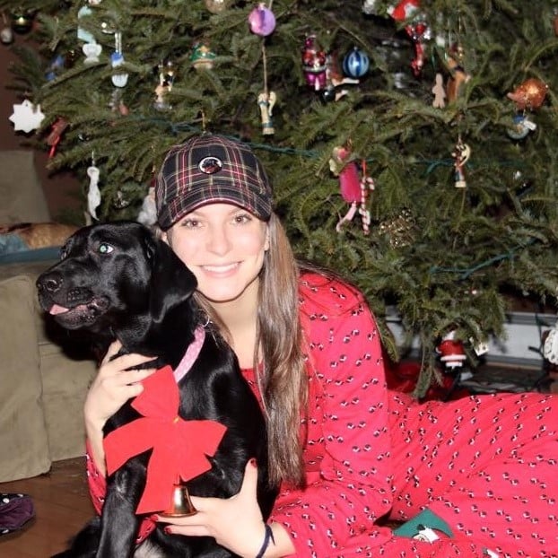 Claire Johannesen with dog in front of Christmas tree