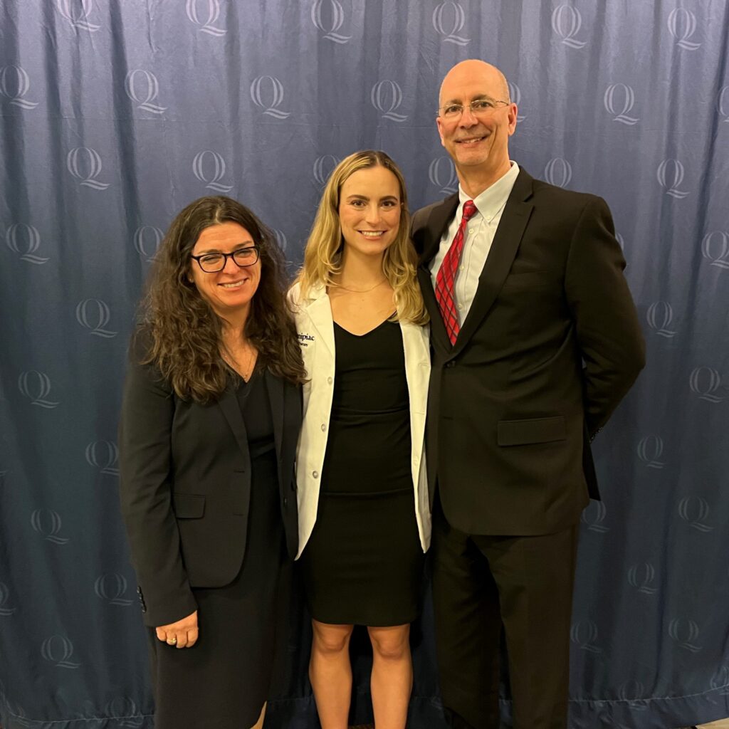 Claire Johannesen with parents during graduation