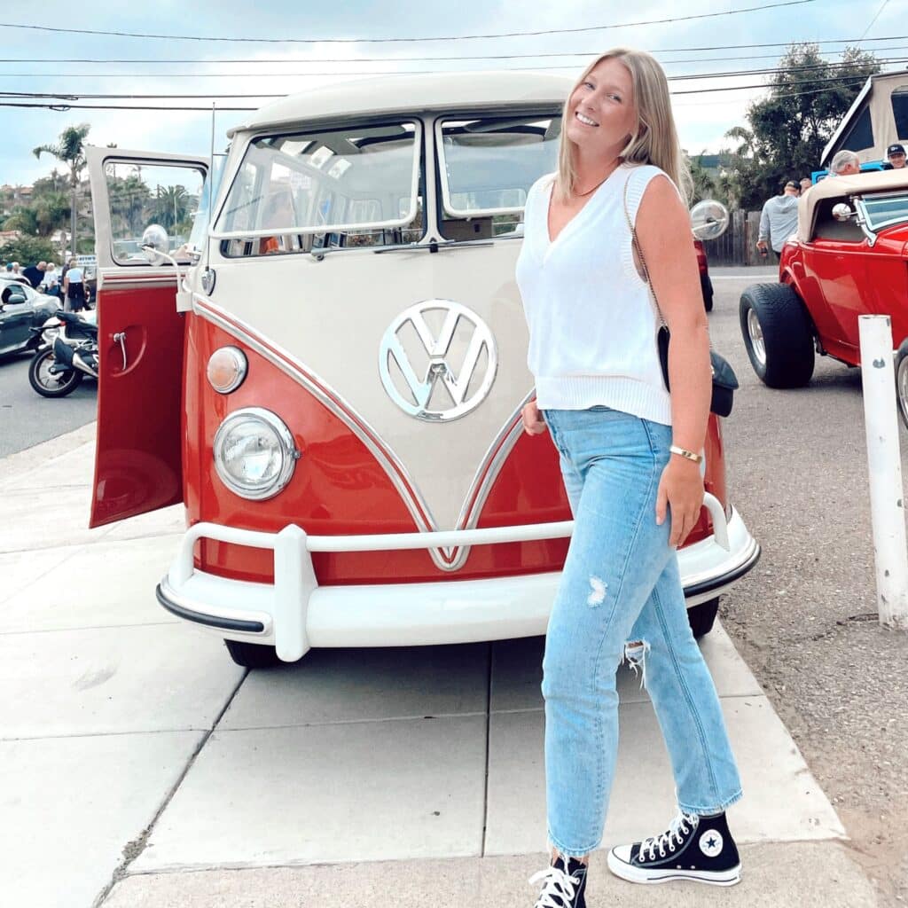 Claire Ruth standing in front old volks wagon